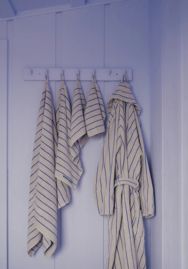 Bongusta Naram bathroom towel in Moonbeam and Ultramarine, soft fabric with a stylish striped design, hanging on a towel rack.