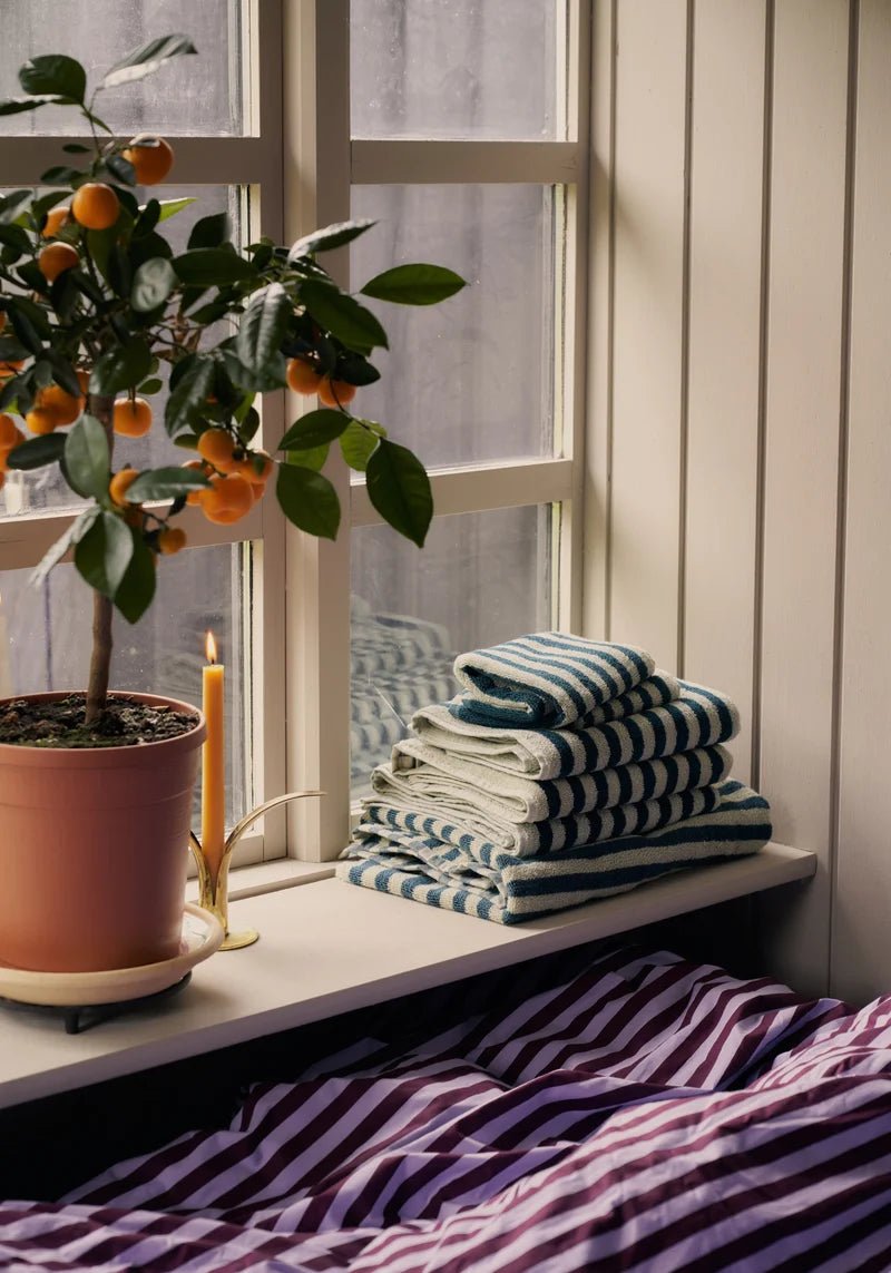 Bongusta Naram bathroom towel in sea foam and deep teal with soft, plush fabric and decorative pattern.