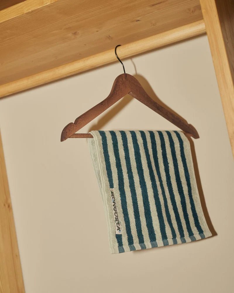 Bongusta Naram bathroom towel in sea foam and deep teal with soft, absorbent fabric and decorative woven pattern.