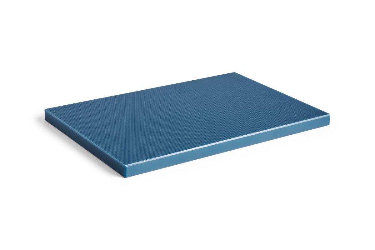 Large HAY kitchen chopping board in dark blue, showcasing a smooth wooden surface perfect for food preparation.