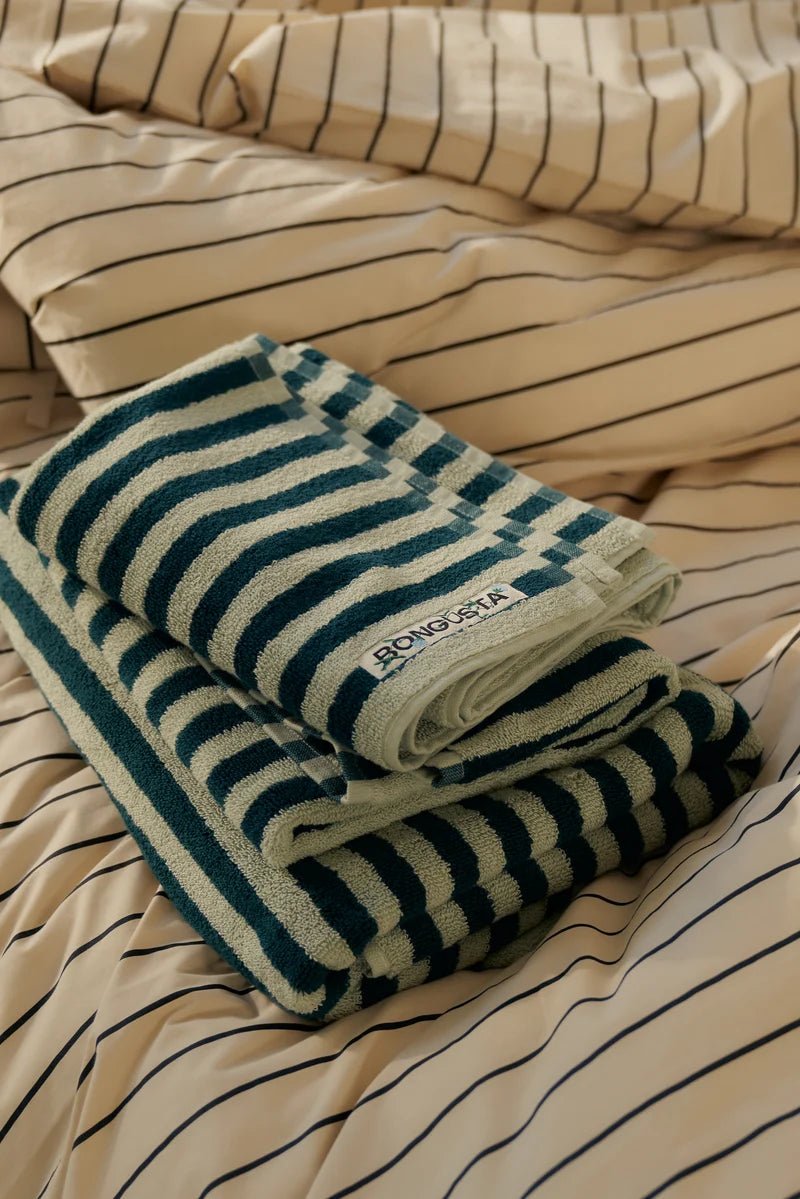Sea foam and deep teal Naram bathroom towel by Bongusta, displayed folded with soft, plush fabric texture.