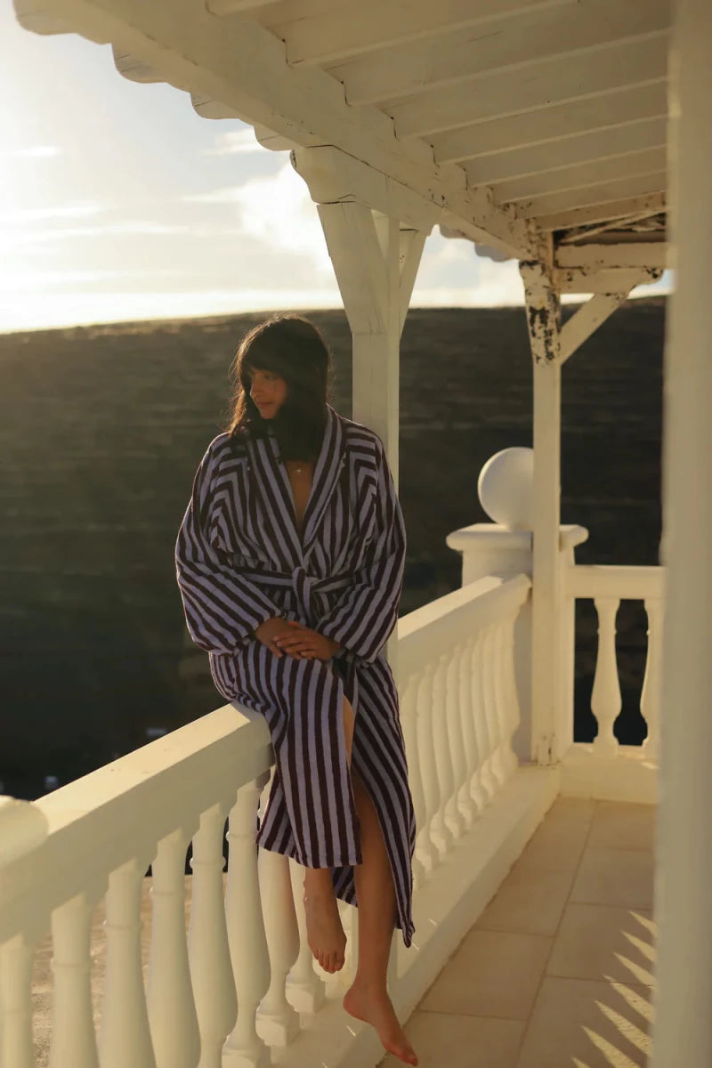 Bongusta Naram wine and lavender blue bathrobe with soft fabric, shown hanging on a hook in a bathroom setting.