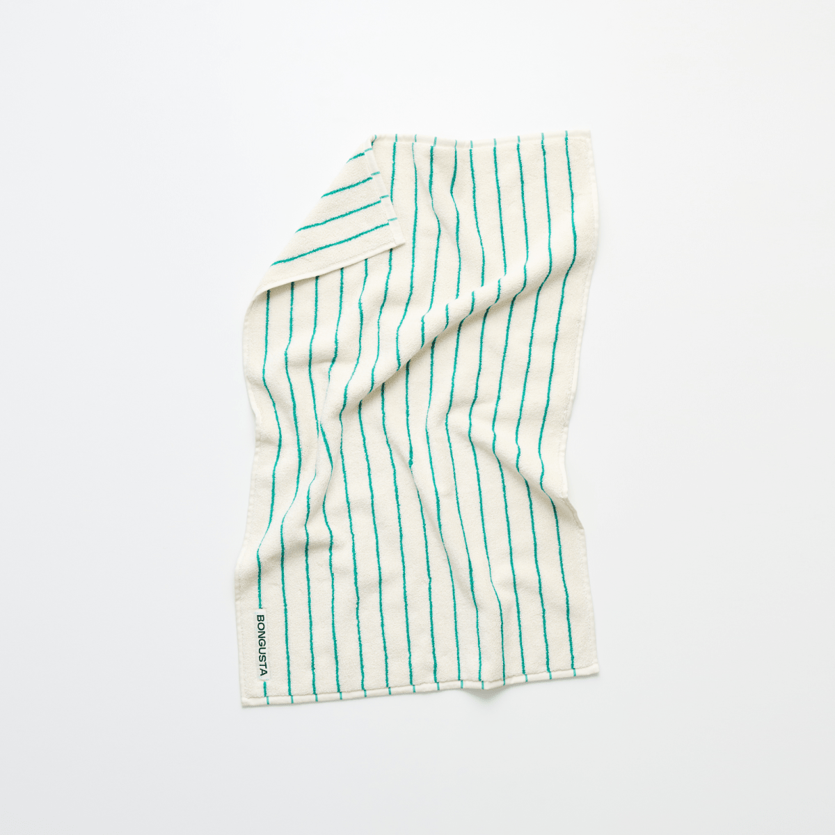 Bongusta Naram Bathroom Towel in pure white and grass green, showing soft, absorbent fabric with folded edges.