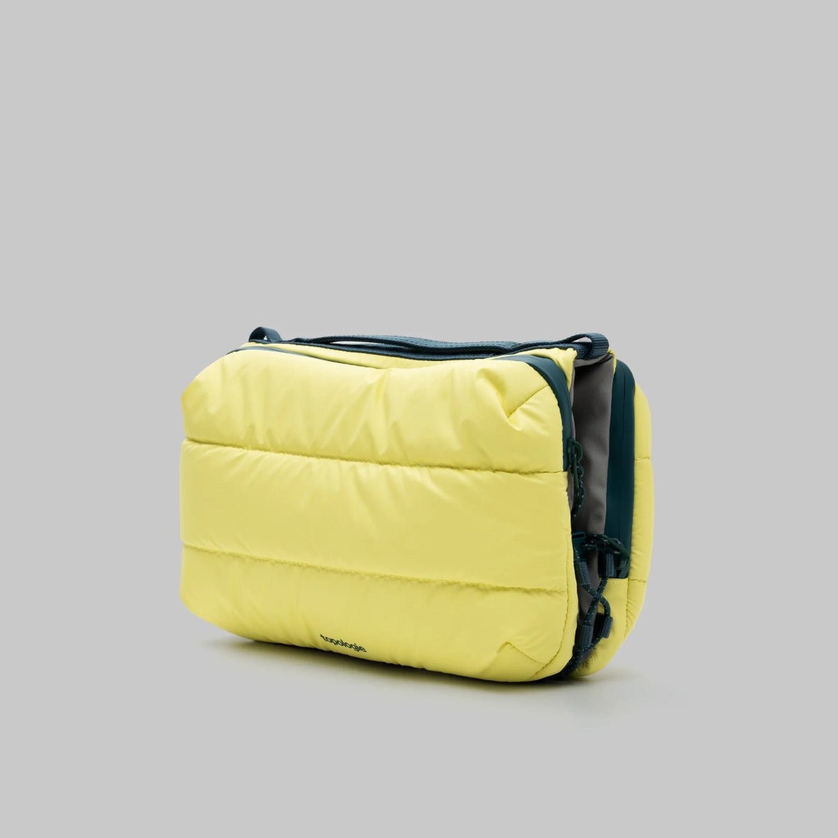 Large puffy canary yellow bottle bag from topologie bag on a gray background