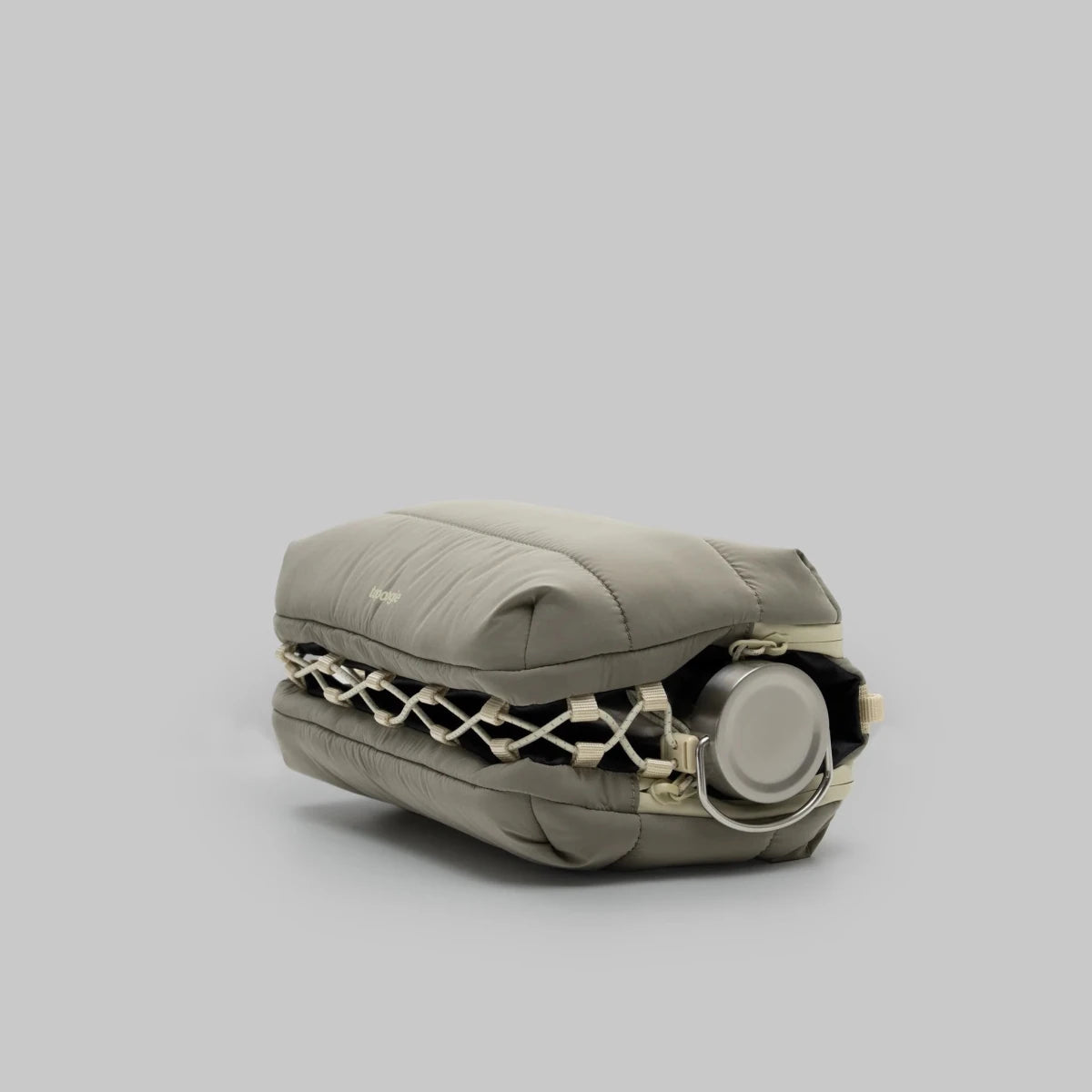 Large moss putty puffy bottle bag from topologie on a grey background