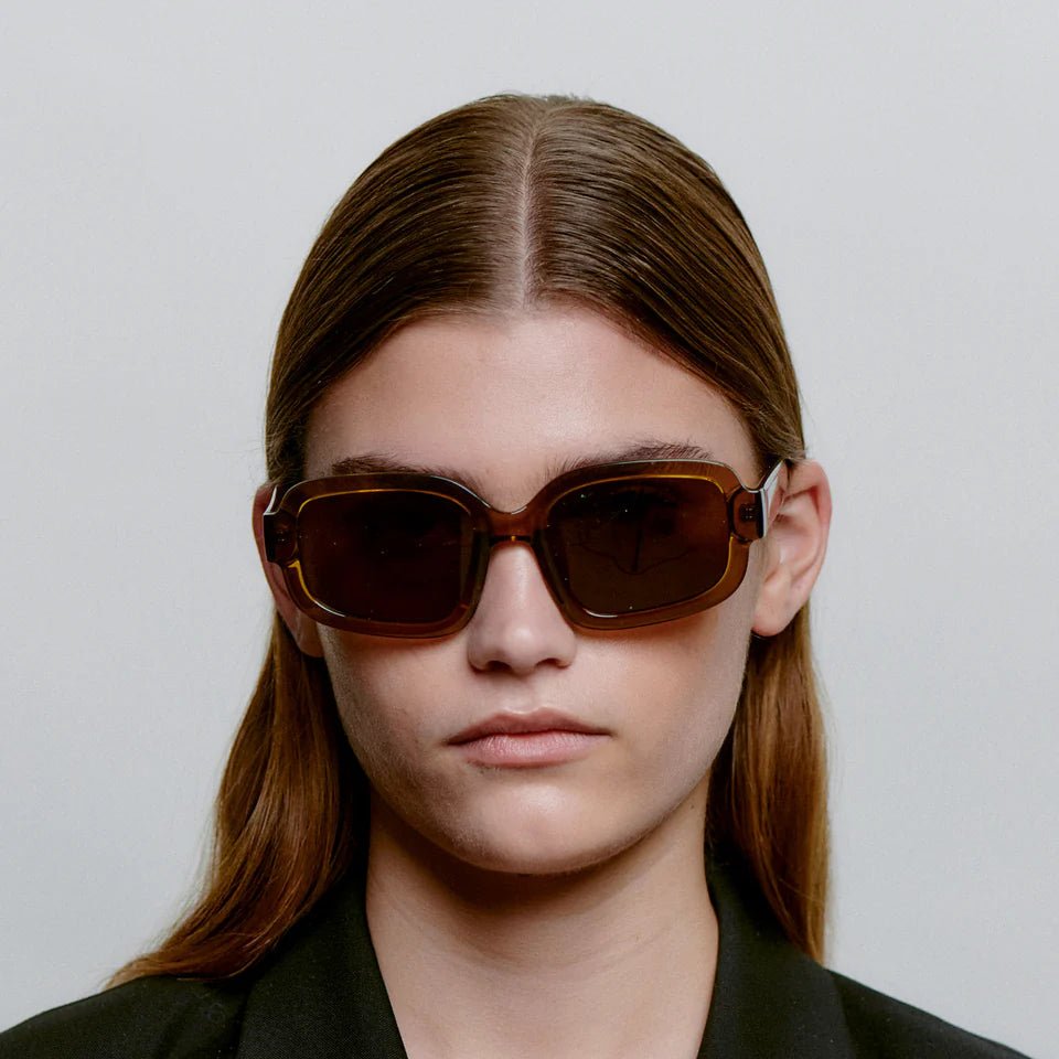 A. Kjaerbede Pluto sunglasses with round frames and tinted lenses, stylish eyewear for sun protection.