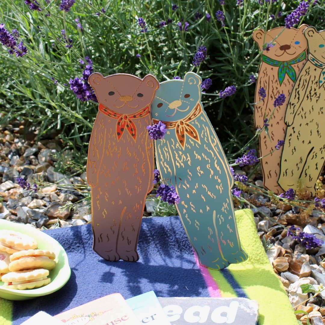 Gold bear-shaped bookmark by Ark Colour Design, featuring a cute bear figure for marking pages in books.
