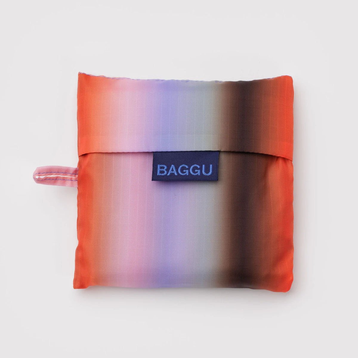 Baggu bag with gradient stripe in poppy and lilac colors, showcasing the stylish, lightweight fabric and spacious design.
