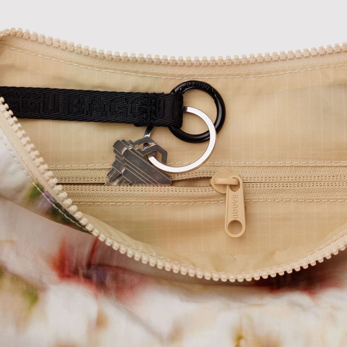 Baggu Crescent shoulder bag in neutral fabric with adjustable shoulder strap and minimalist design, perfect for everyday use.