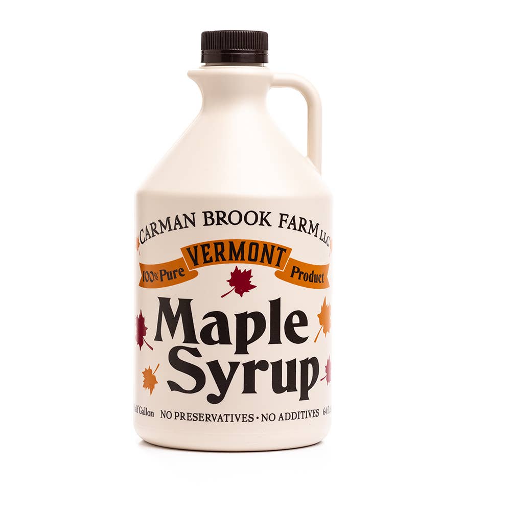 Half-pint jar of Carman Brook Farm Vermont Maple Syrup with amber rich taste, showcasing the syrup's golden color and smooth texture.