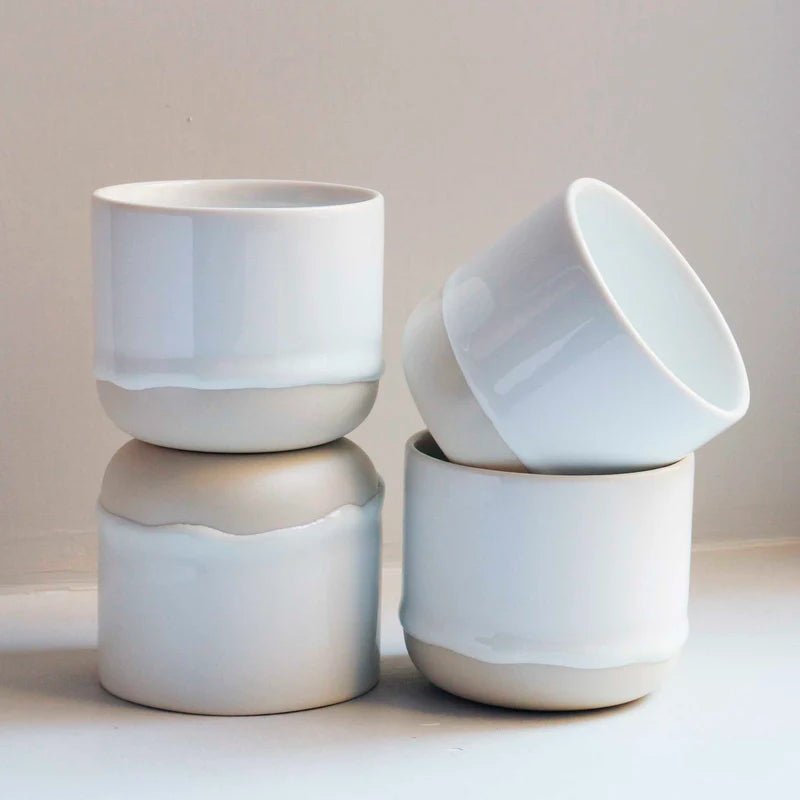 White ceramic Quench Cup by Studio Arhoj with a smooth, glossy finish and rounded shape.