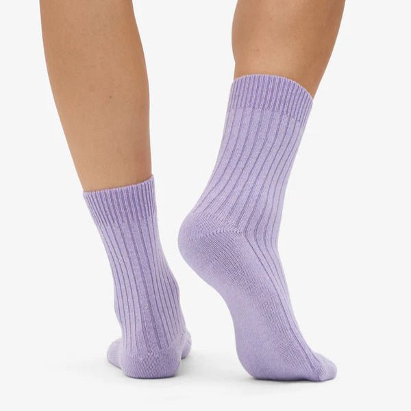 Colorful Standard merino wool blend socks in vibrant, multicolor pattern, showing a close-up of the cozy, soft fabric and colorful design.