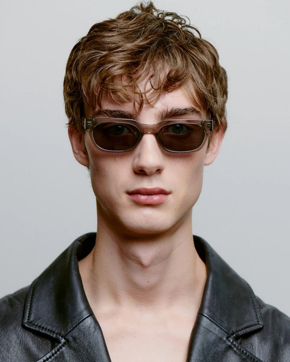 Grey transparent A. Kjaerbede Bror sunglasses with sleek frame and tinted lenses, stylish and lightweight for casual wear.