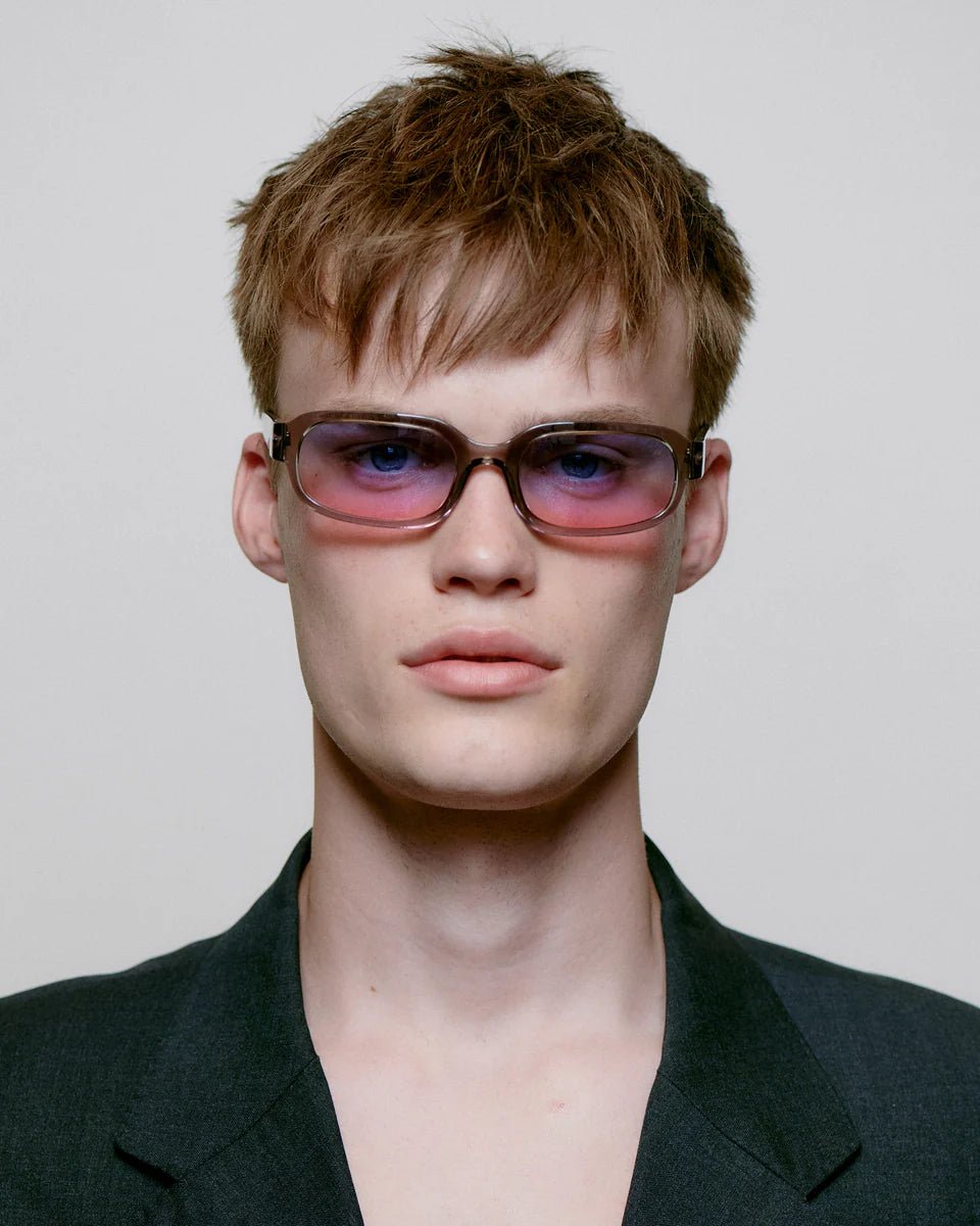 Gray transparent Will sunglasses by A. Kjaerbede with sleek, modern design and tinted lenses, perfect for stylish sun protection.