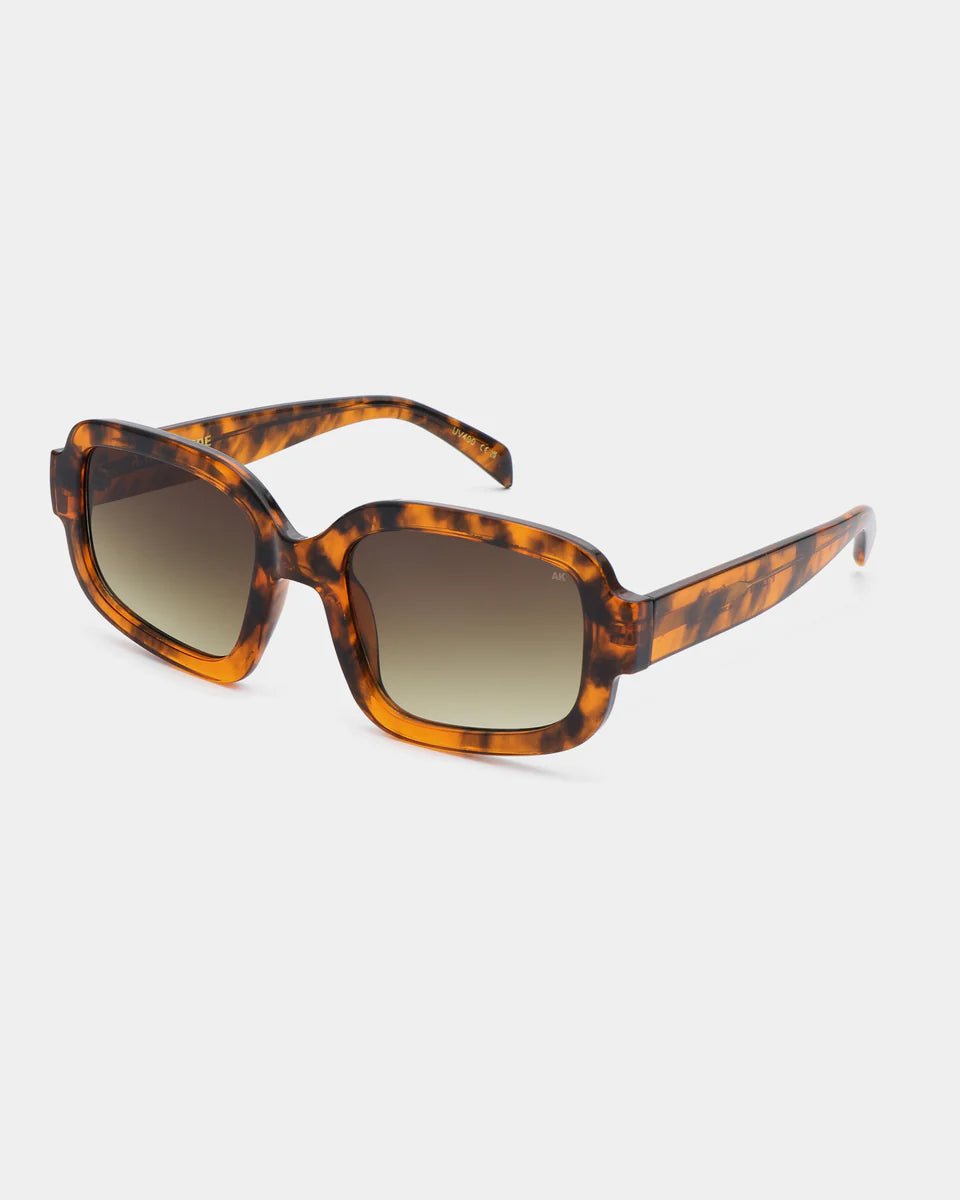 Havana-colored A. Kjaerbede Pluto sunglasses with rounded frames, showcasing stylish eyewear design.