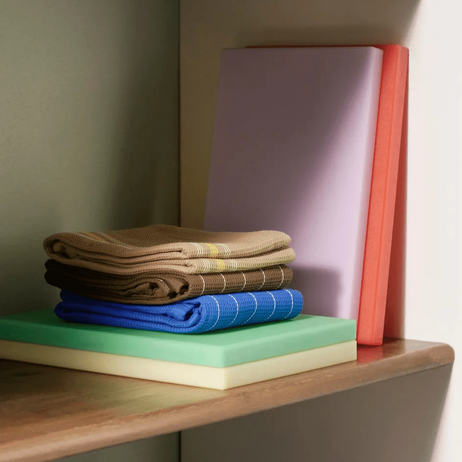Medium green HAY kitchen chopping board with smooth surface and rounded edges for food prep.