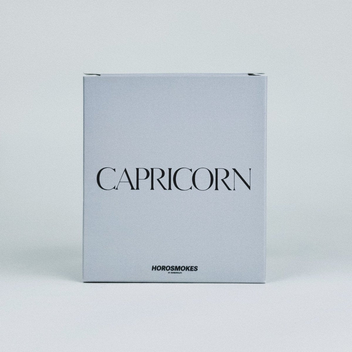 Horosoaps Capricorn Horosmokes candle with a celestial design, featuring a wax candle in a decorative holder for astrology enthusiasts.