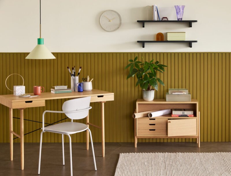Green Hübsch Crayon pendant light hanging from ceiling, modern lighting fixture with a playful crayon shape.