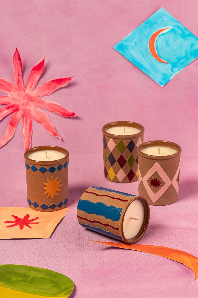 Colorful candles with decorative patterns on a pink background