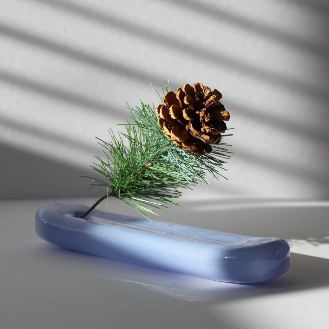 Milky blue Lilo incense holder by MÆGEN featuring a smooth, rounded ceramic design with a central hole for incense sticks.