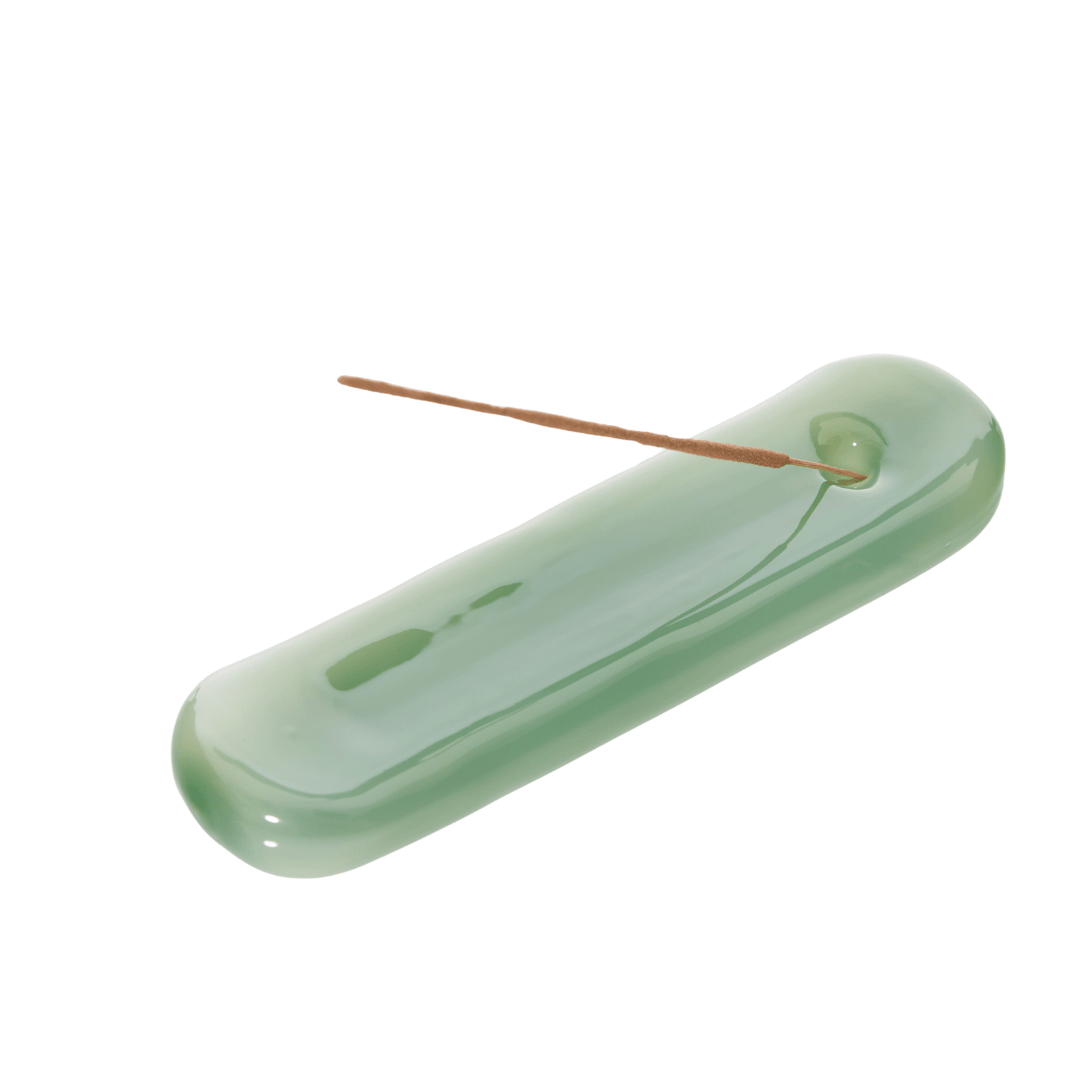 Sea green Lilo incense holder by MÆGEN, featuring a modern, curved design perfect for holding incense sticks securely.
