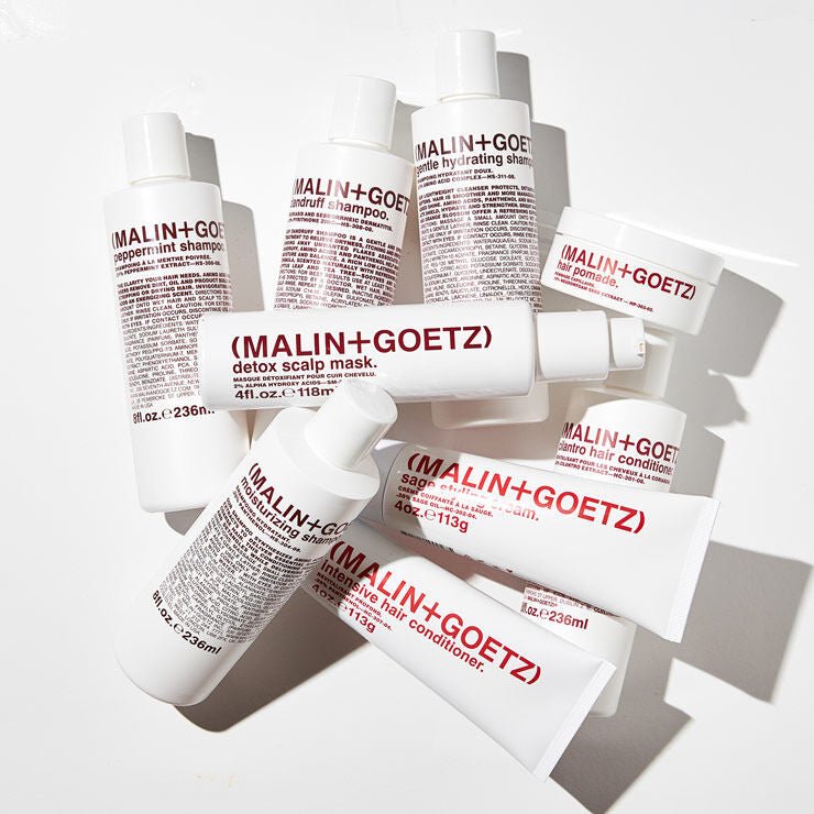 Malin+Goetz hair pomade in a jar, showing a smooth, shiny styling product for hair with a clean, minimalist design.