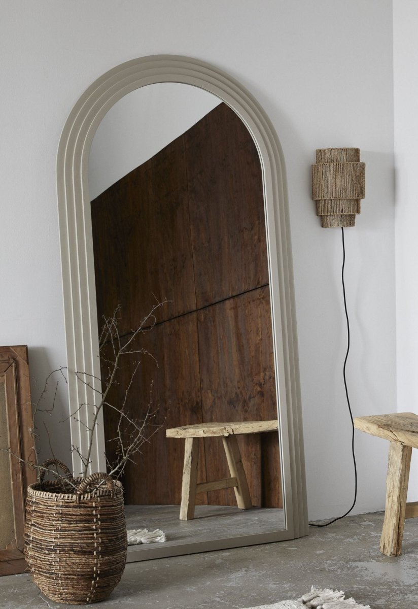 Nordal A/S FALCO mirror in sand color, featuring a sleek modern design with a round frame and reflective glass surface.