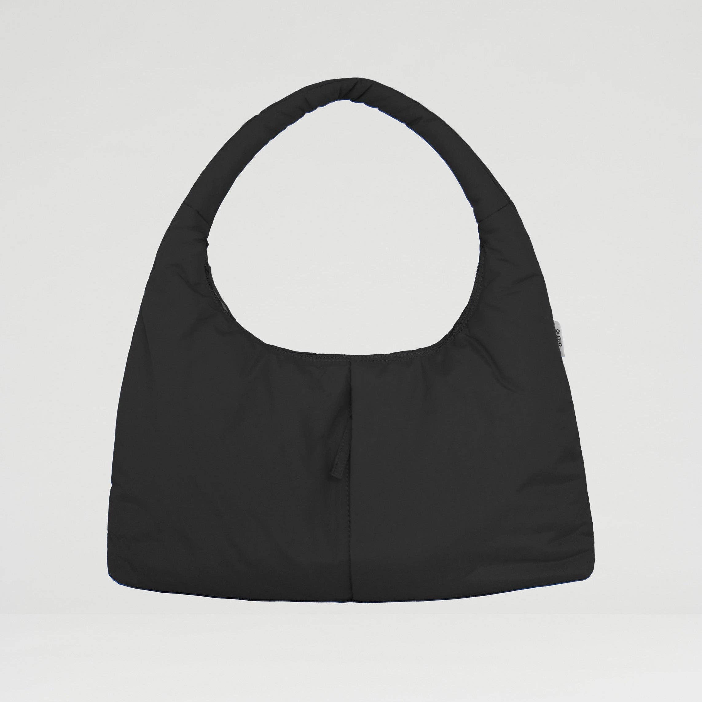 Black handbag on a light gray background