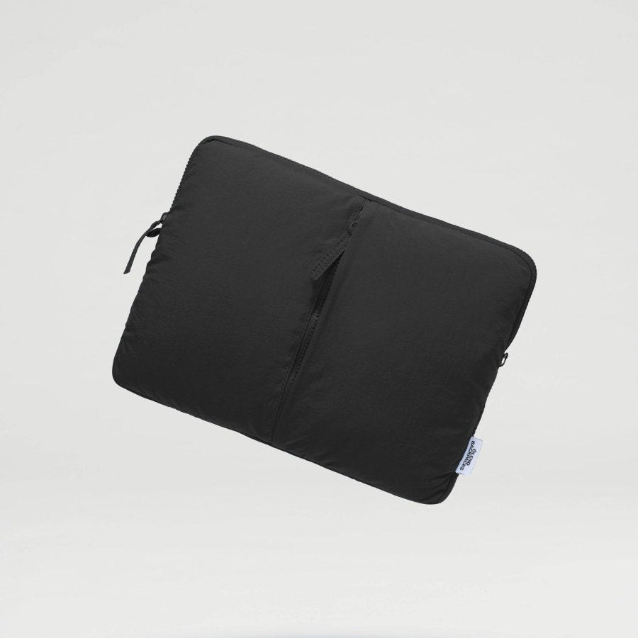 Black Ölend Backpacks padded laptop sleeve for 13 and 14-inch laptops, featuring protective padding and sleek design.