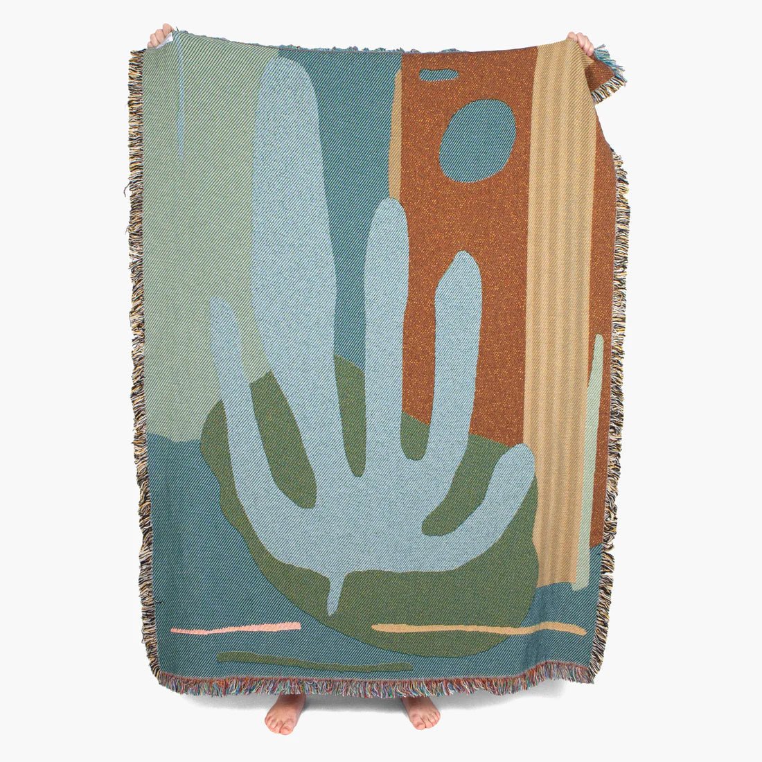 Blue tonal woven blanket with an abstract desert landscape
