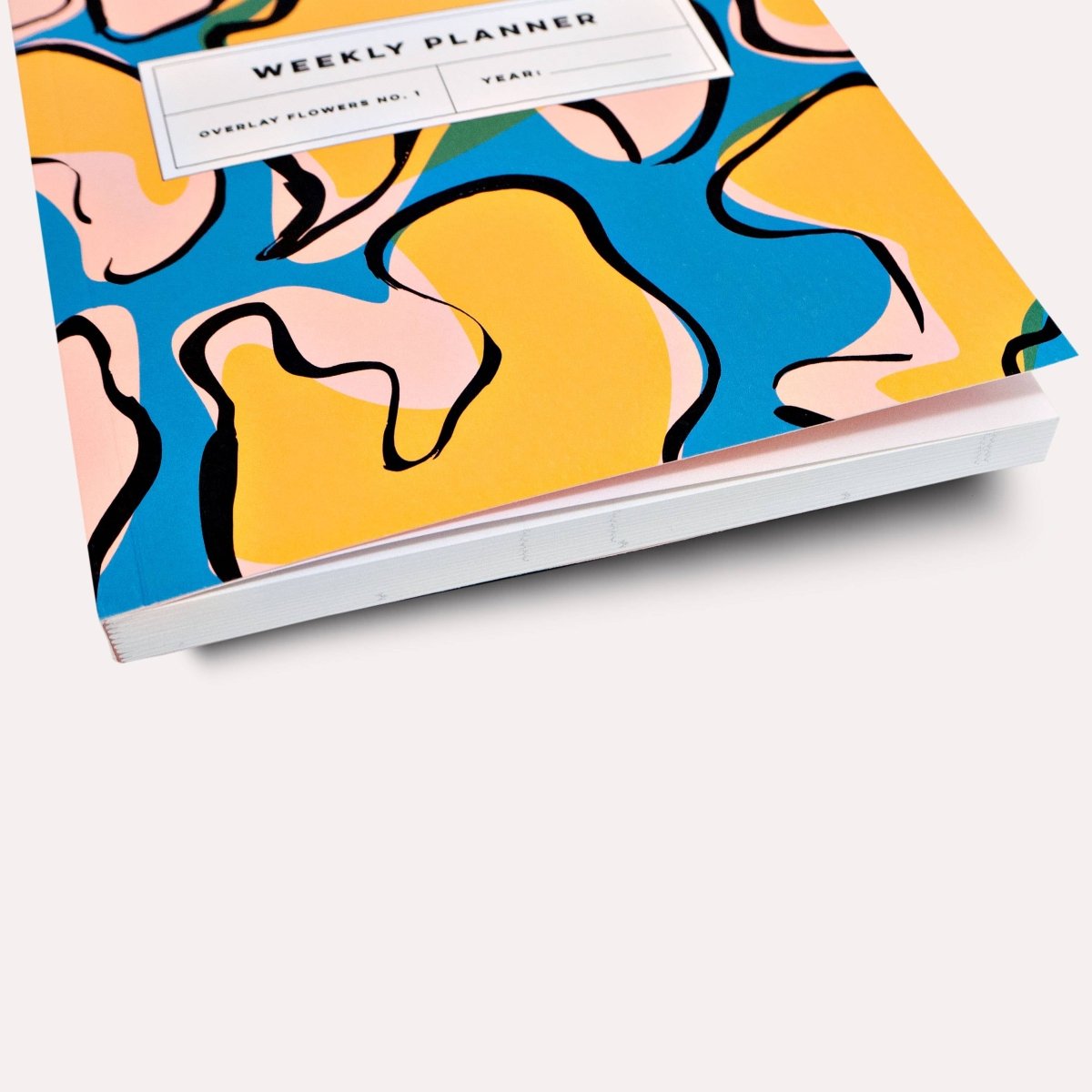 Overlay Flowers No. 1 weekly planner book by The Completist featuring a floral cover and lay-flat design for easy planning.