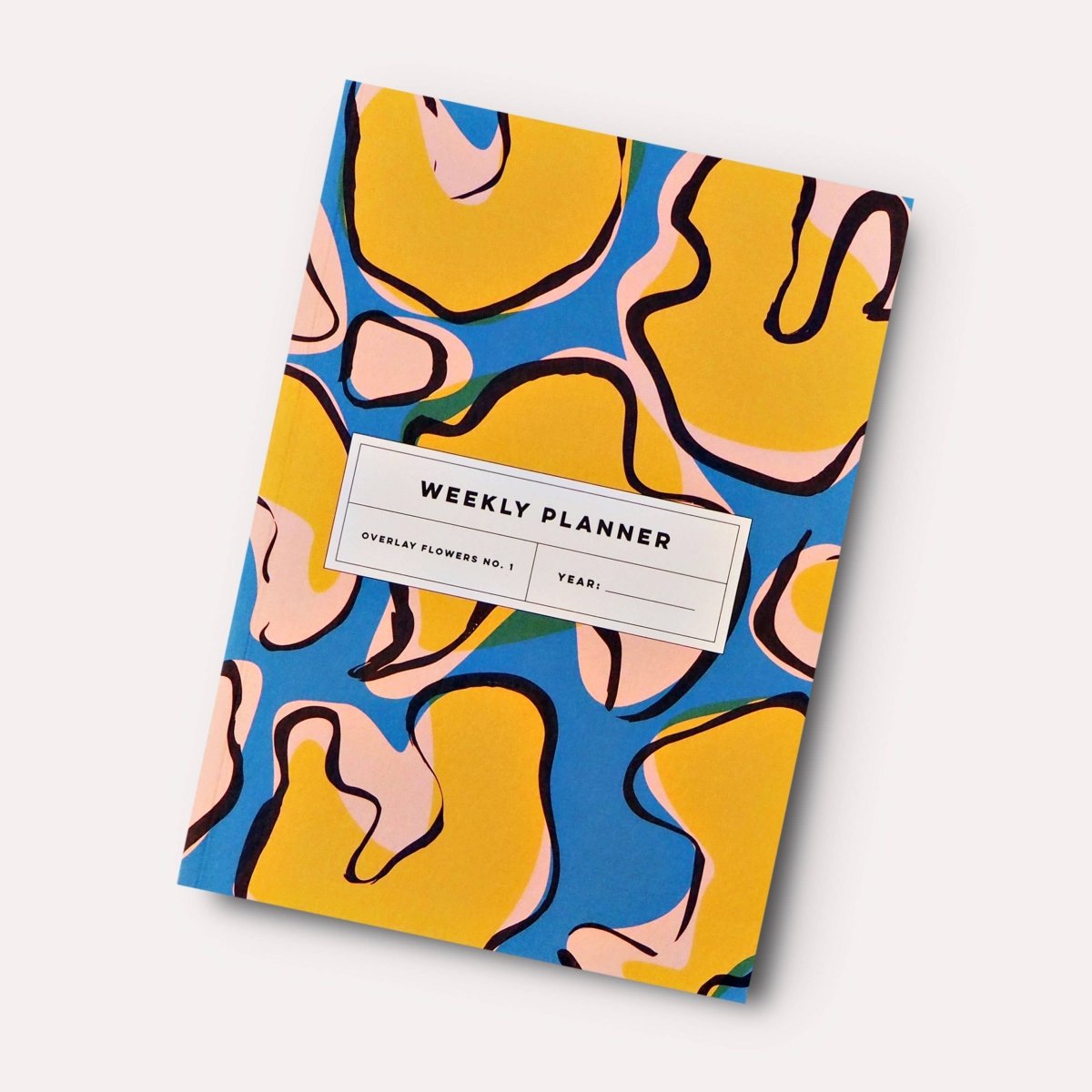 The Completist Overlay Flowers No. 1 lay-flat undated weekly planner book with floral cover design.
