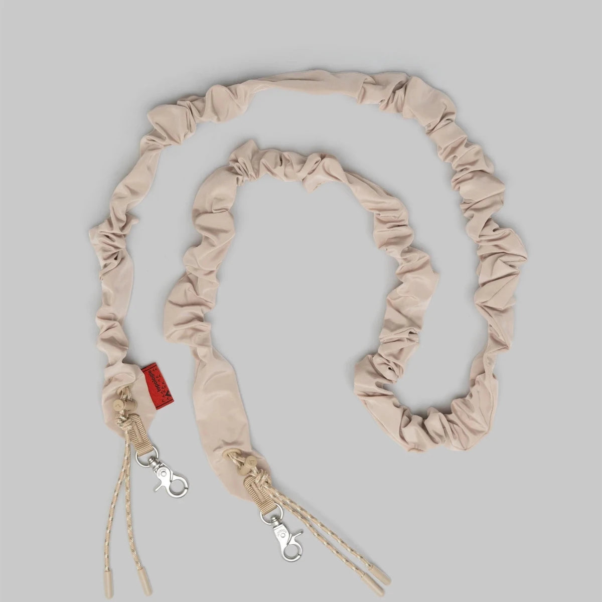 Topologie Bungee Strap for bags, black elastic cord with metal hooks, versatile accessory for securing items.