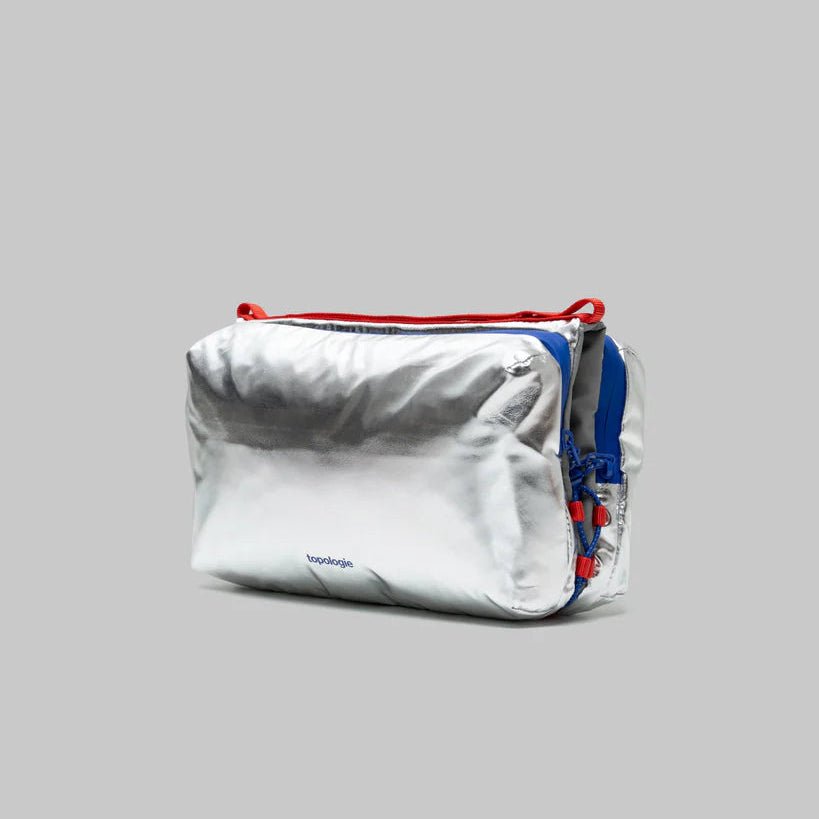 Large Topologie Bottle Sacoche bag in durable fabric, featuring a sleek design with adjustable strap for convenient carrying.