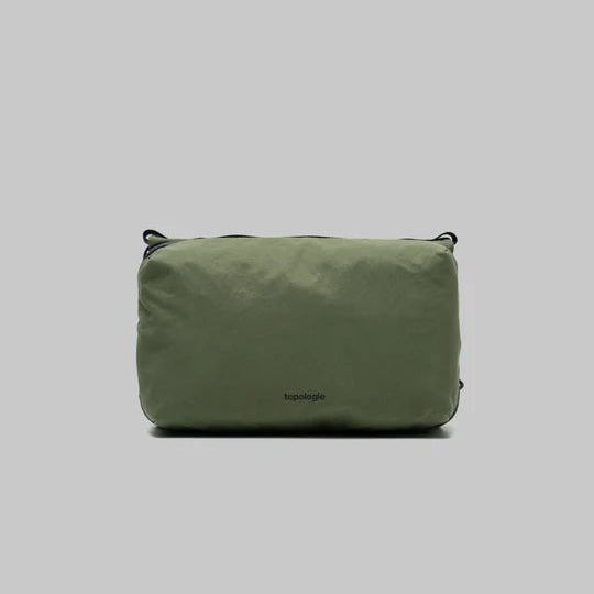 Large Topologie Bottle Sacoche bag with adjustable strap and sleek design, perfect for carrying bottles on the go.