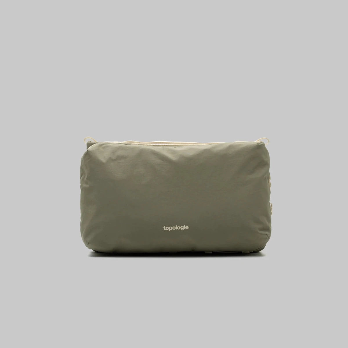 Large Topologie Bottle Sacoche bag with adjustable strap and minimalist design, perfect for carrying bottles and essentials.