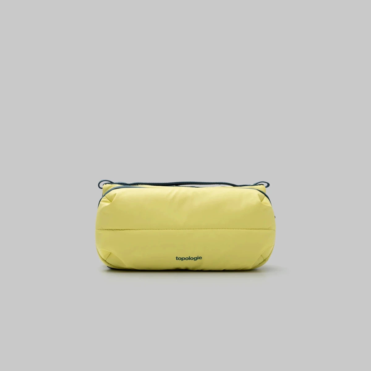 Yellow bottle bag with 'topologie' branding on a gray background