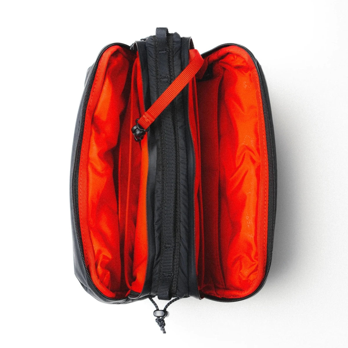 large puffy black bottle bag from Topologie on a grey background