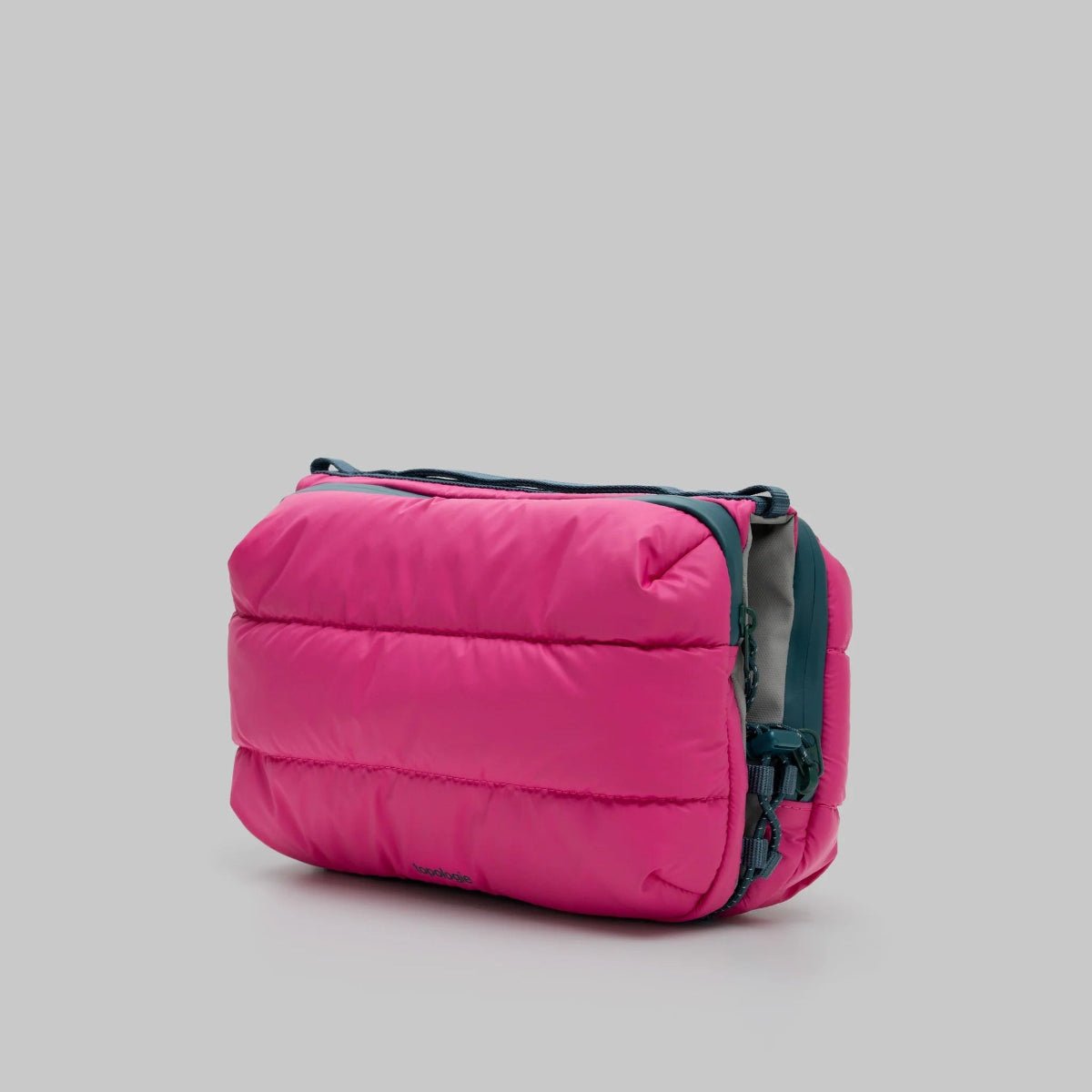 Large pink puffy bottle bag from topologie on a grey background