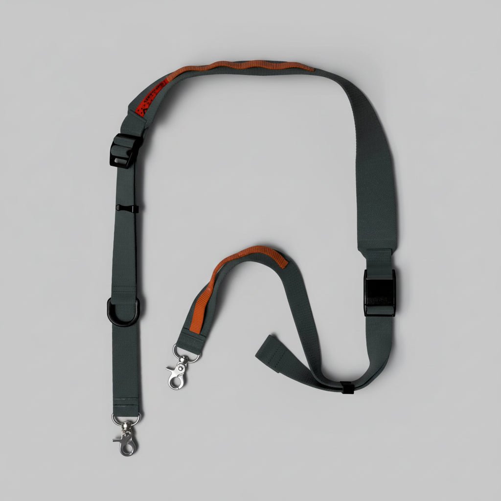 Wide utility sling strap by Topologie, showing durable nylon material and adjustable buckle for versatile carrying options.