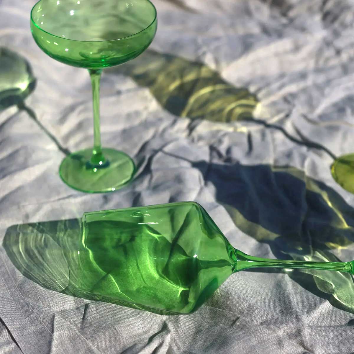 Set of two Ufer Glassware coloured wine glasses in vibrant wasabi green, featuring elegant curved design for stylish wine serving.