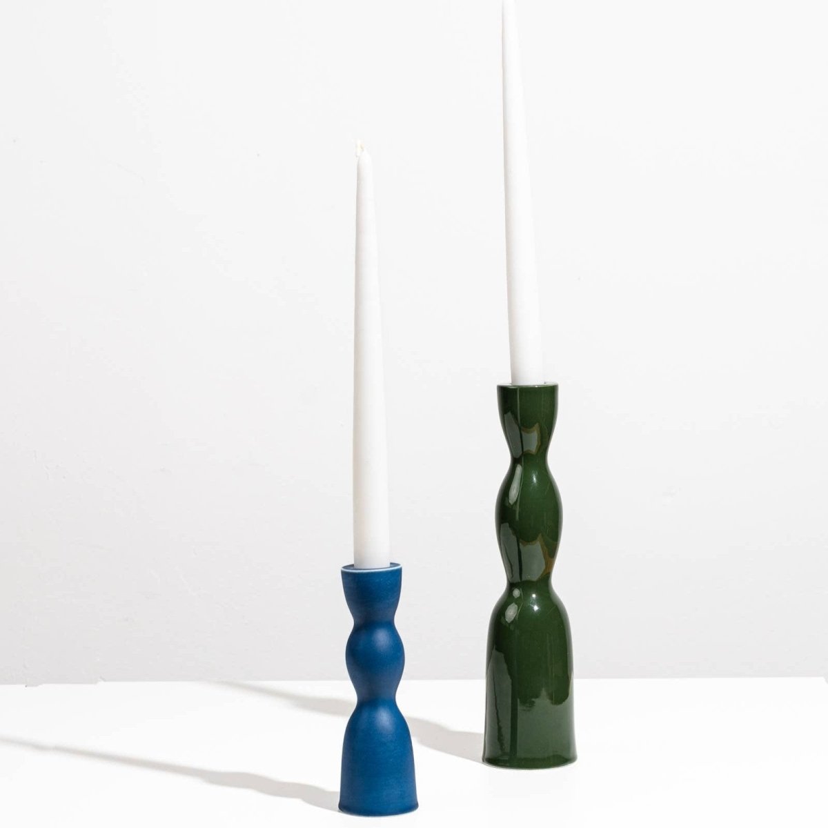 Tall dark green YOD&CO Wave Candleholder with a sleek, modern design suitable for tabletop or mantel display
