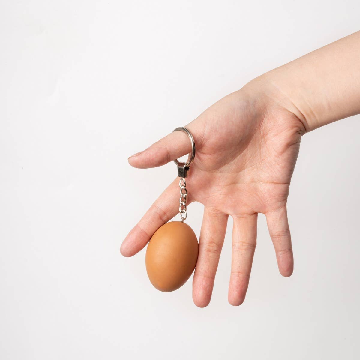Yumazing Connectrade AG keychain with a colorful egg-shaped accessory, made of durable materials for everyday use.