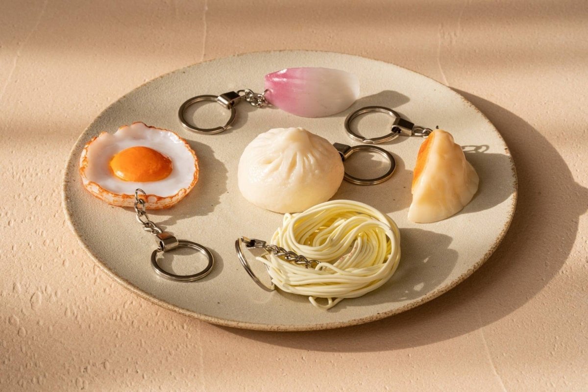 Steamed Momo keychain by Yumazing, featuring a cute, detailed steamed dumpling design on a keyring.