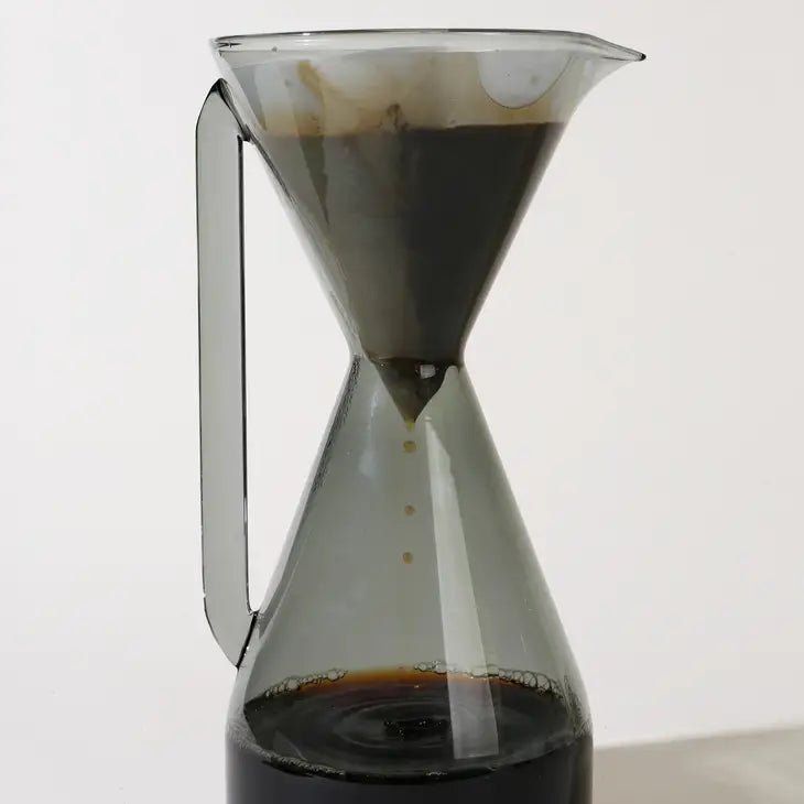 Yield coffee pour-over carafe with glass body and black handle for brewing fresh coffee.