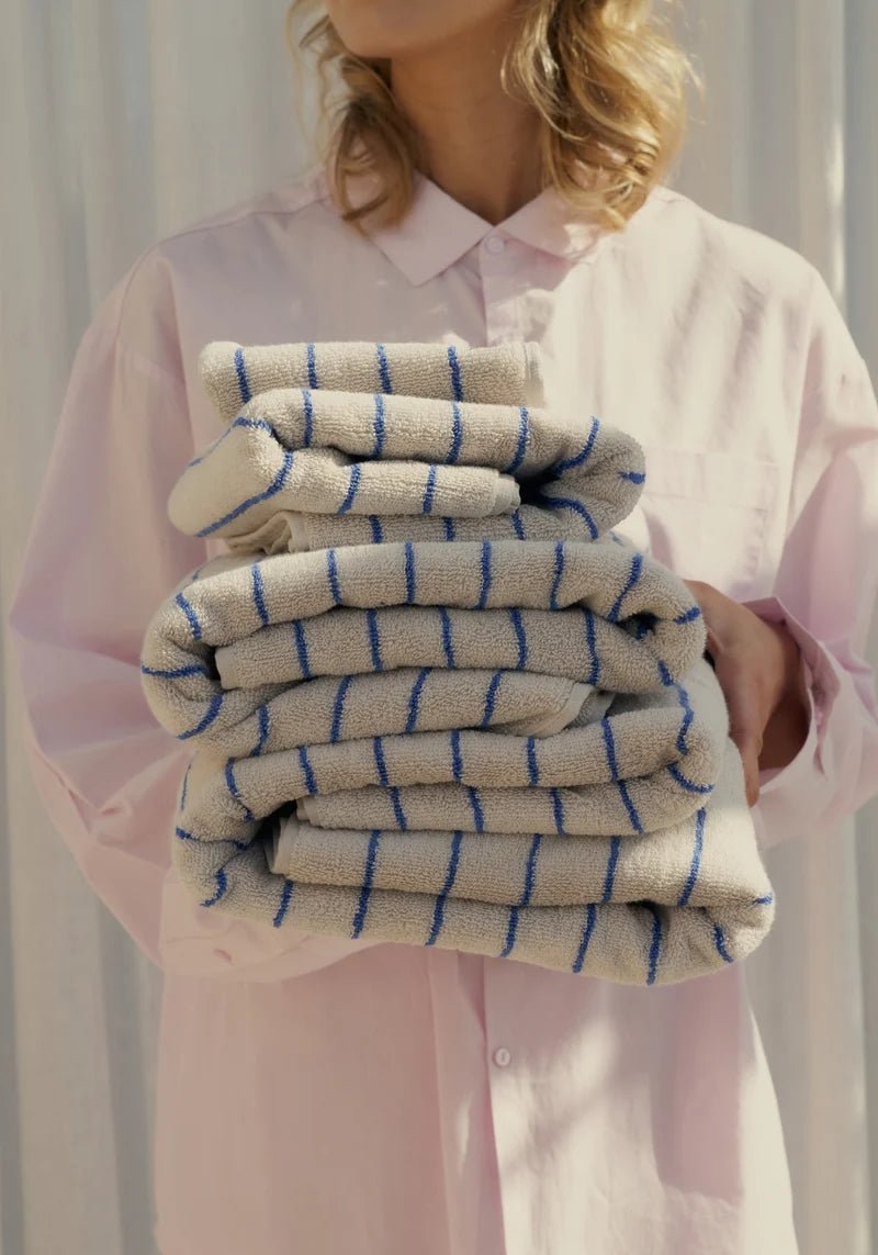 Bongusta Naram bathroom towel in Moonbeam and Ultramarine with soft, plush fabric and modern striped design.