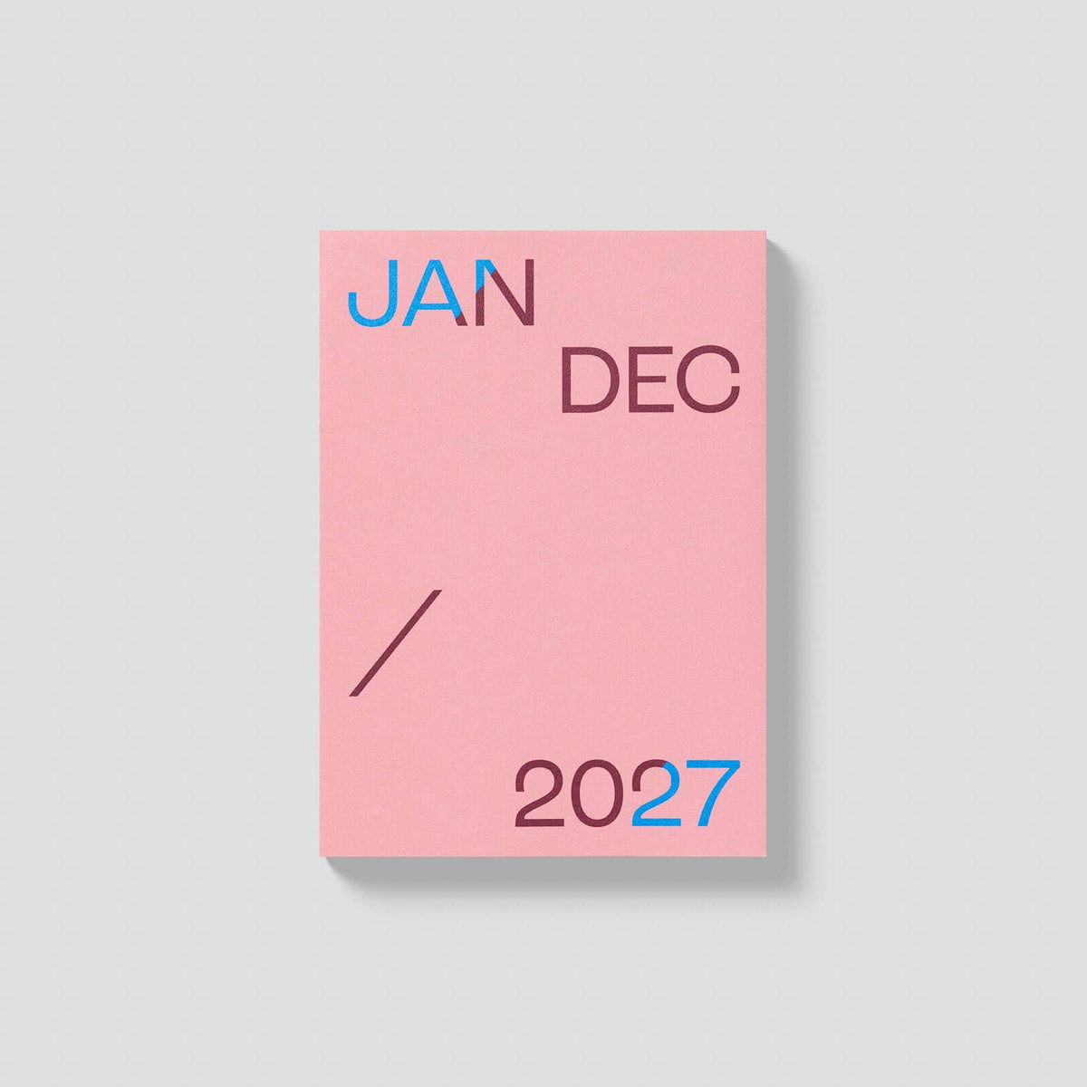 Dusty pink 2027 mishmash planner with time-block layout, open to show weekly pages and organized design