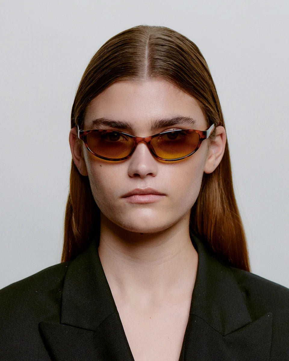 A woman wearing A. Kjaerbede Alexa sunglasses with havana frames, front view showing stylish eyewear on her face.