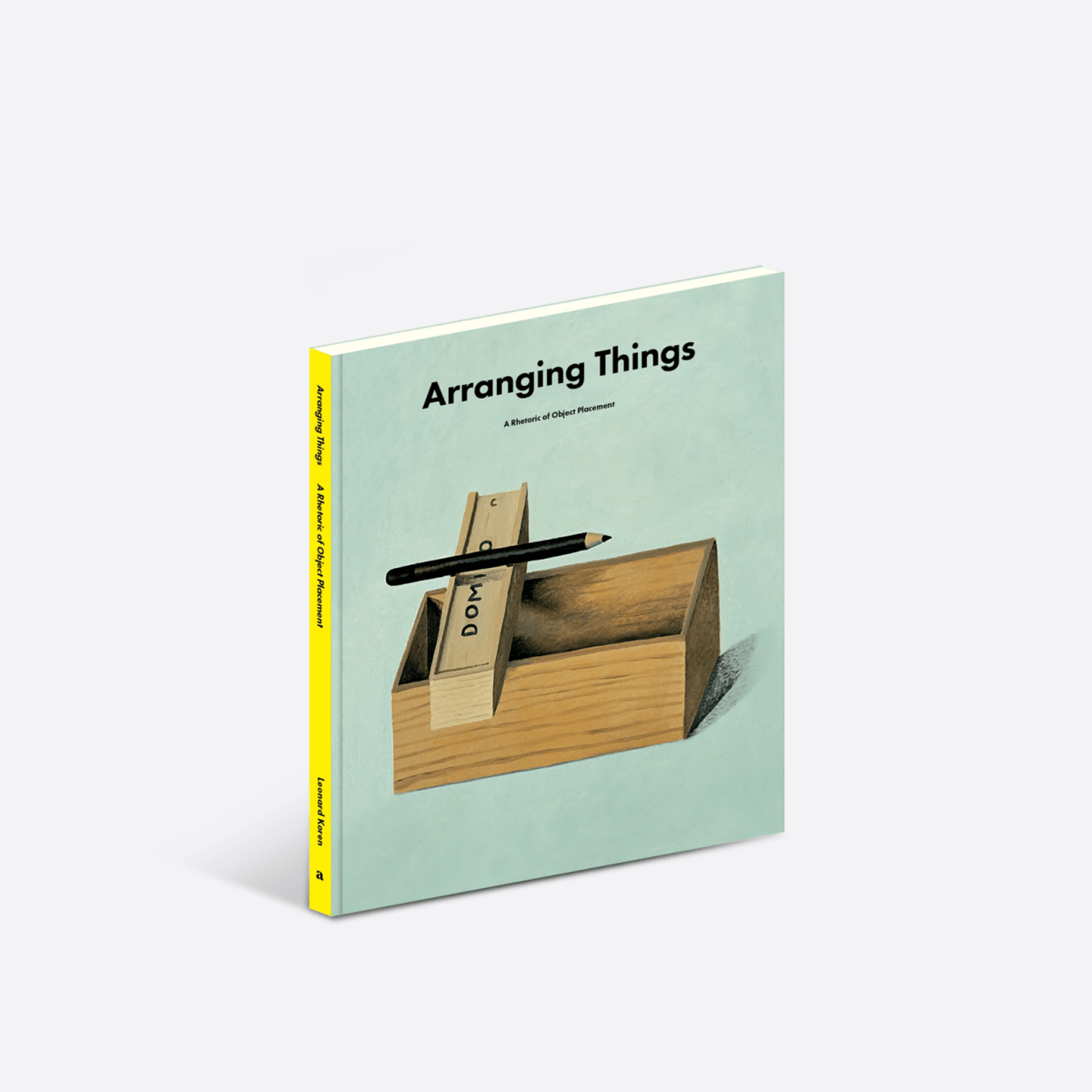 Open design book titled "Arranging Things" by Apartamento Publishing showcasing interior arrangement ideas and creative layouts.