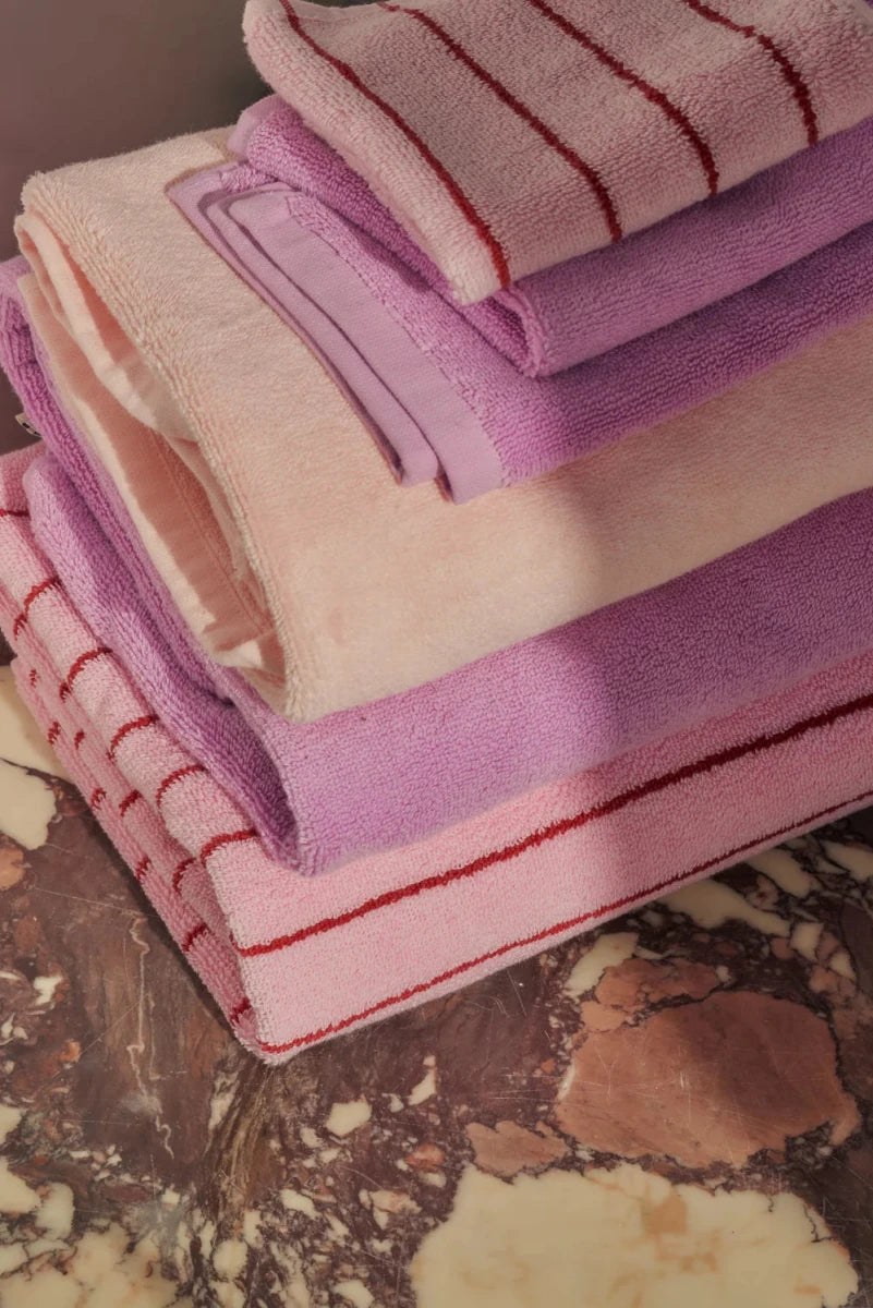 Soft blush Naram towel by Bongusta, displayed in a bathroom setting, showcasing its plush texture and elegant design.